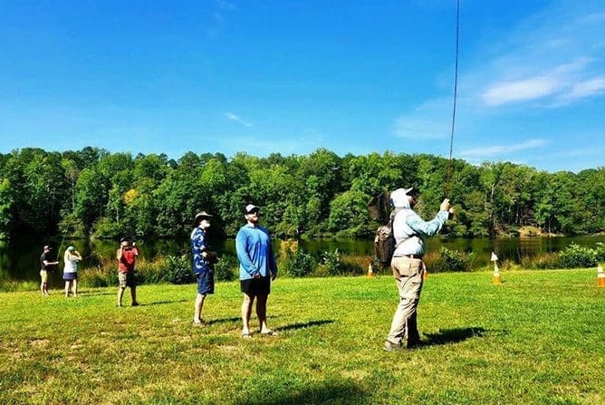 A group of people standing in the grass.