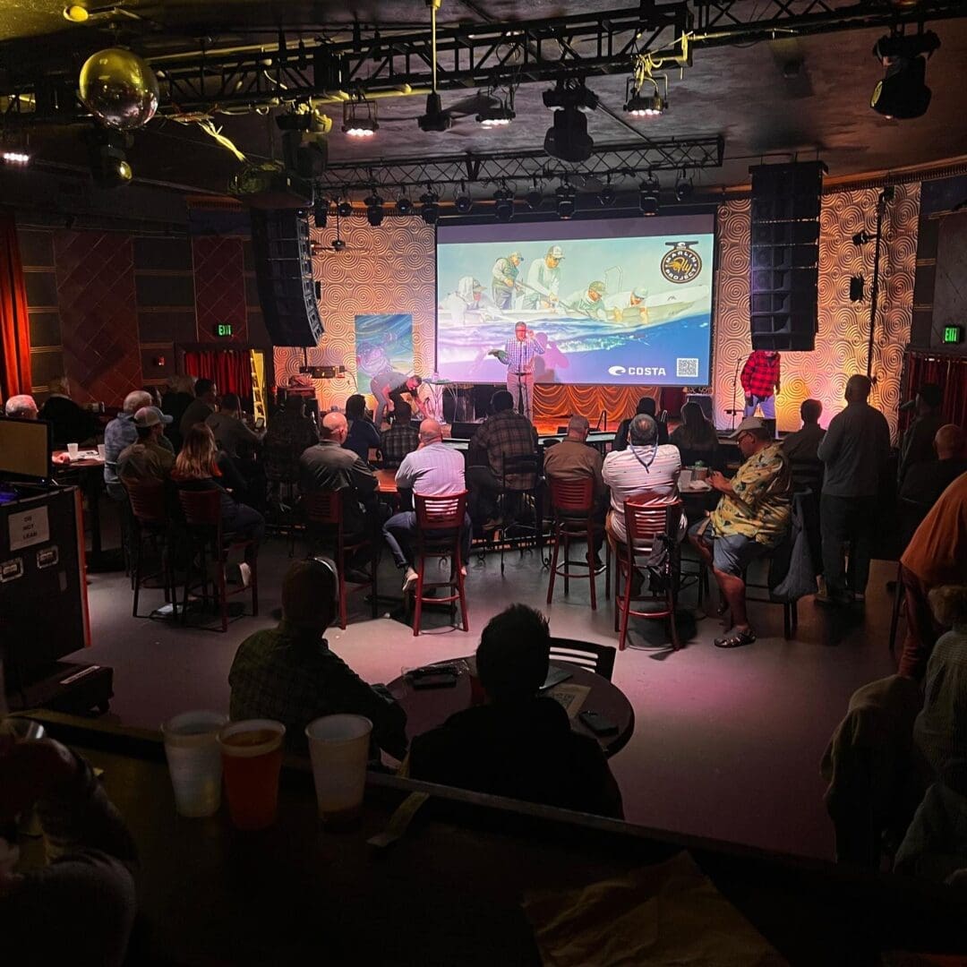 Audience listening to fishing presentation.