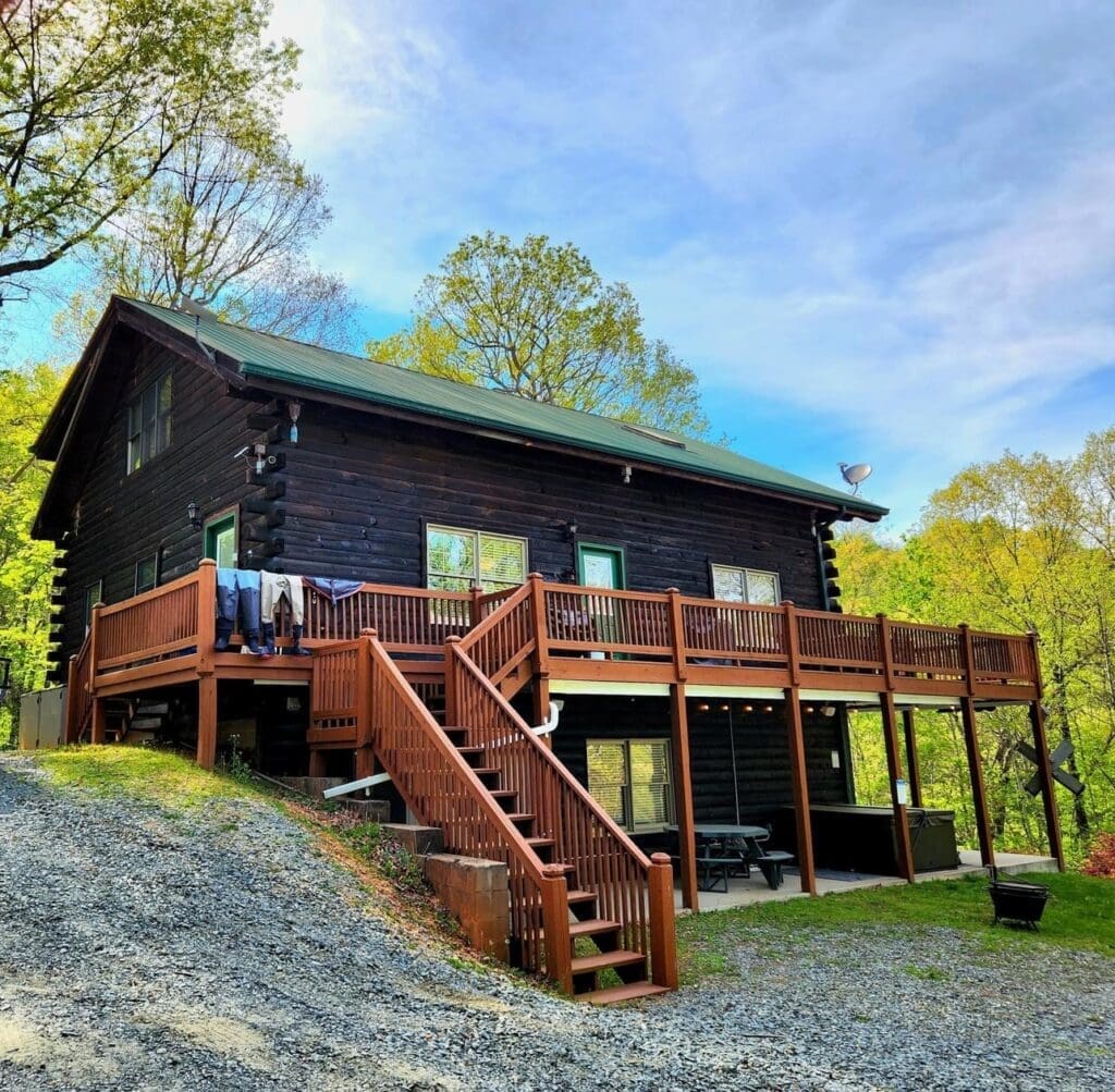 Rustic log cabin with wrap-around deck.
